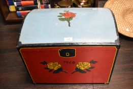 A mid century hand-painted dome-topped trunk, decorated with roses and date 1960