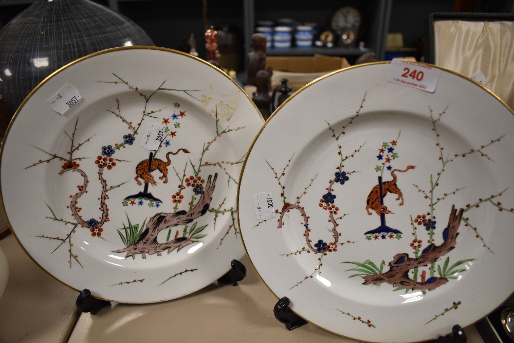 Two early 19th century plates, marked for Derby, having animals depicted to centres with foliate