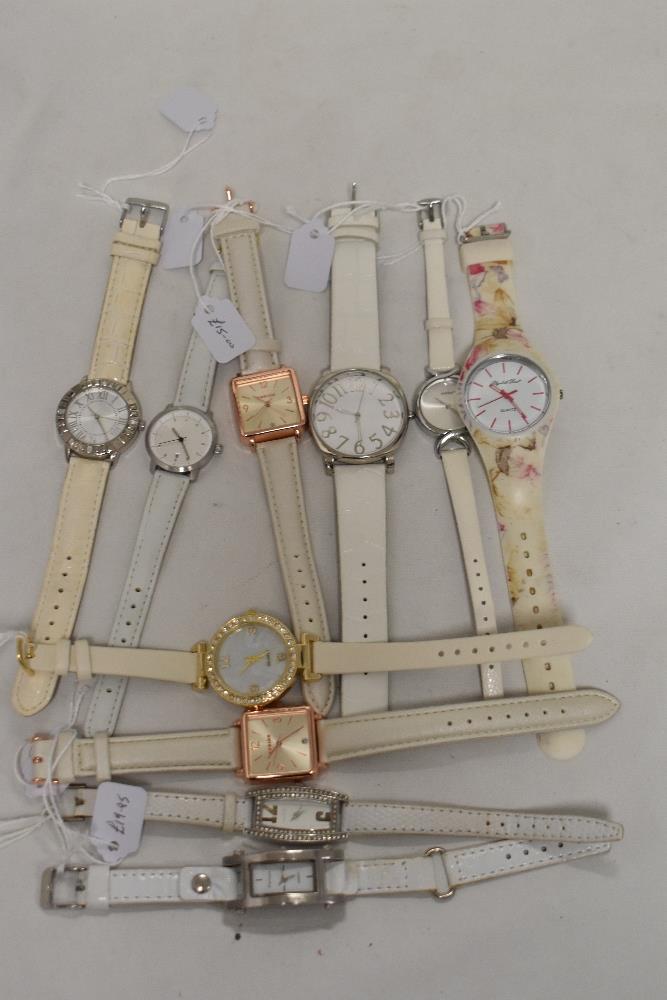 Ten ladies watches in silver tones, one having lilac face.