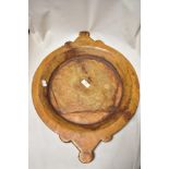 An antique wooden carved dough or bread bowl in an artisan farm house design