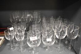 A large set of mid century clear glasses including wine, brandy, cordial, water and whisky