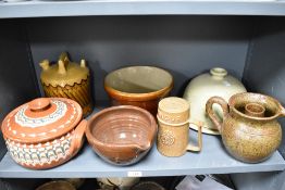 A selection of stoneware kitchenalia, to include flagons, bowls, flour caster, cheese stand and