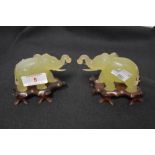 A pair of 20th century Jade stone mirrored elephant figures on wooden bases, 5cm tall approx