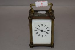 A 20th century French carriage clock with four glass panel design and visible escapement