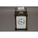 A 20th century French carriage clock with four glass panel design and visible escapement