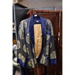A mid century oriental smokers jacket in blue silk satin having gold thread embroidery with a set of