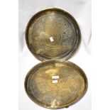 A pair of early 20th century Indian brass trays with chase work Islamic designs