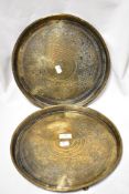 A pair of early 20th century Indian brass trays with chase work Islamic designs