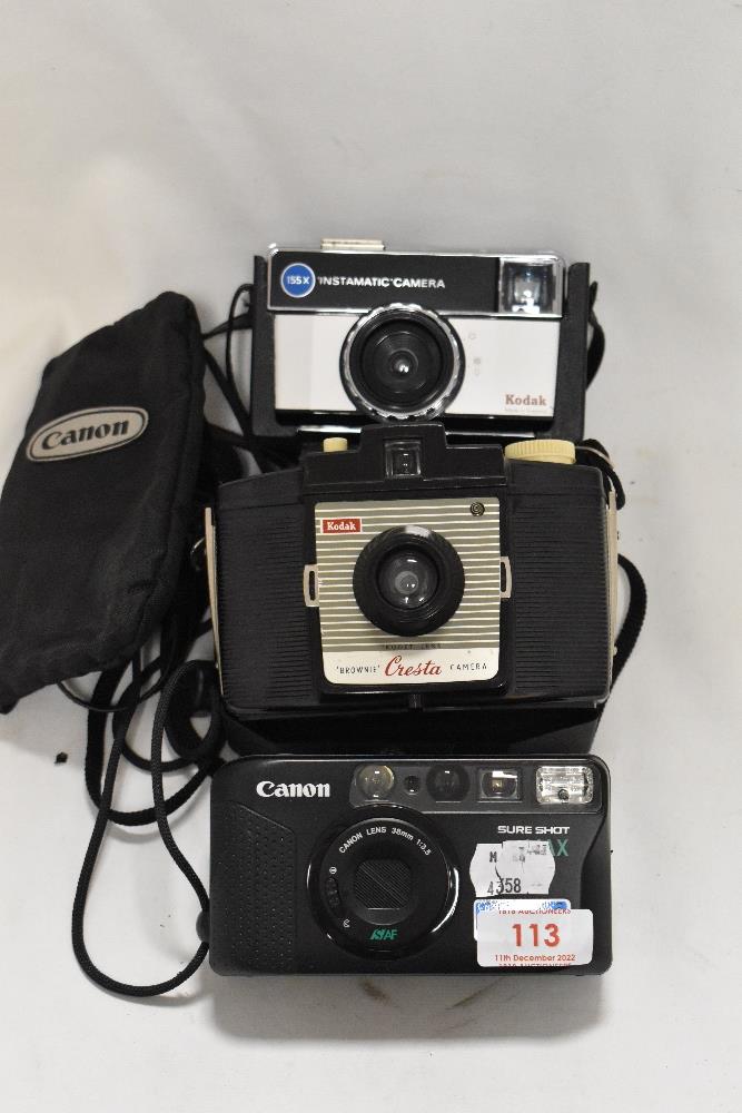 Three modern cameras including Cannon Sure shot, Kodak Instamatic and Kodak Brownie