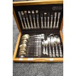 A canteen of Oneida plated cutlery, containing two associated spoons and napkin rings.