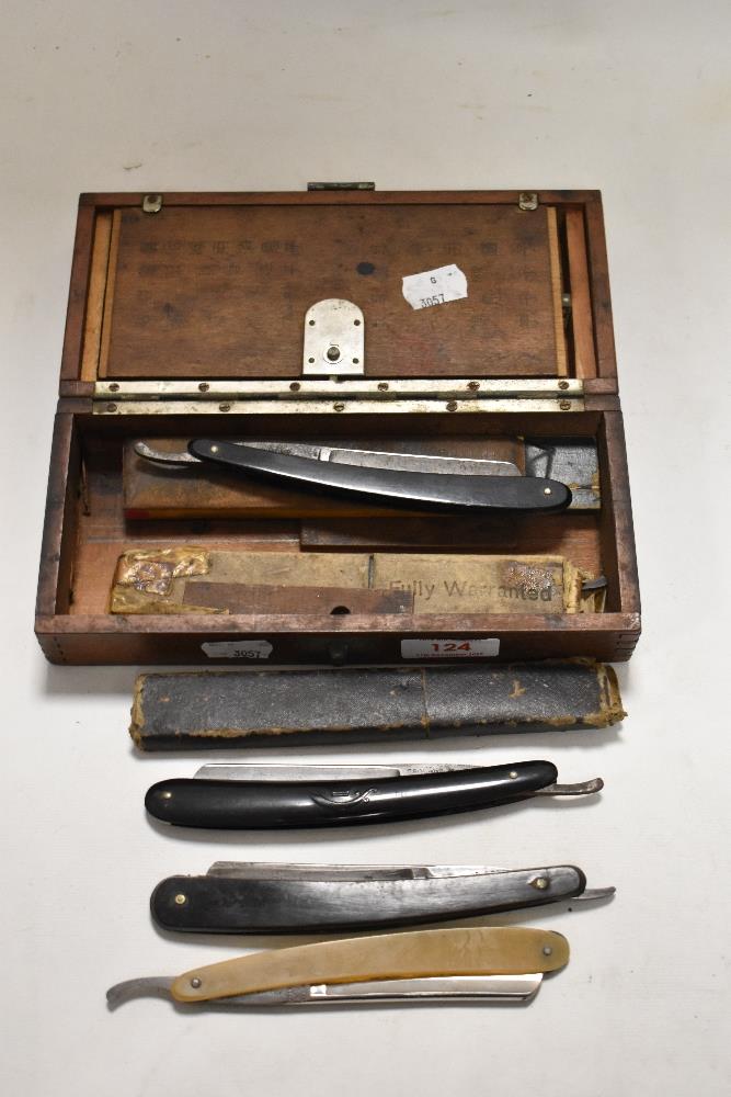 A box full of antique cut throat razors.