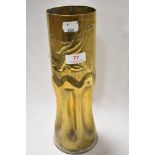 A military ammunition shell worked as Trench art with fluted base and bird design 29cm tall approx