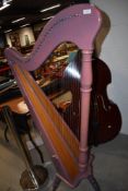 A traditional harp, having lilac finish on triple turned leg base, height approx. 150cm