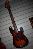 A Squier by Fender 'P' bass, with after market and original scratch plates, and padded gig bag