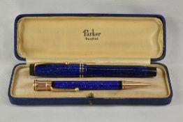 A boxed Parker Duofold button fill fountain pen and propelling pencil set in lapiz blue with two