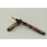 A Conway Stewart 388 lever fill fountain pen in rose marble with single broad band and two narrow