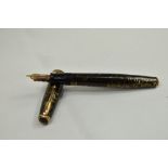 A Parker Vacumatic fountain pen in brown with broad decorative band to the cap having Parker