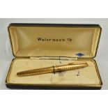 A boxed Waterman Converter Fill fountain pen in gold chaised pattern having 14ct nib. Very good