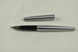 A Sheaffer Stylist cartridge fountain pen in brushed steel with gold clip and white dot having