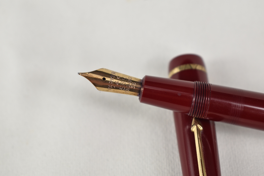 A Parker Duofold Senior aeromatic fill fountain pen in red, having decorative band to the cap having - Image 2 of 3