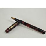 An Ingersoll lever fill fountain pen in red black marble with single narrow band to cap having