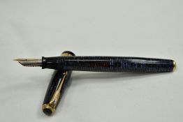 A Parker Vacumatic fountain pen in dark and pale blue having a broad ribbed band to the cap and blue