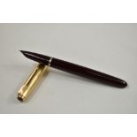 A Parker 51 aeromatic fill fountain pen in burgundy with gold filled cap. Approx 13.9cm in very good