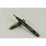 A Conway Stewart Dinkie 550 lever fill fountain pen in green brown marble with single band to the