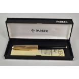 A boxed Parker 61 converter fountain pen in black with rolled gold cap. Approx 13.4cm in good