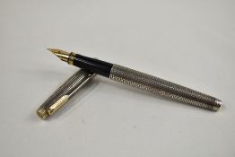 A Parker 75 fountain pen in Sterling silver Cisele design having Parker gold nib. Approx 12.8cm in