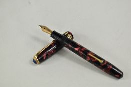 A Conway Stewart 58 lever fill fountain pen in red black marble with single broad band and two