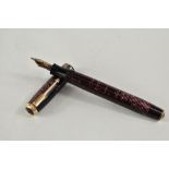 A Parker Vacumatic pump fill fountain pen in rose with three narrow bands to the cap having Parker