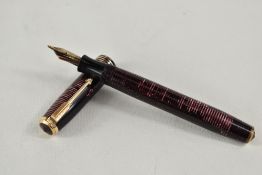 A Parker Vacumatic pump fill fountain pen in rose with three narrow bands to the cap having Parker