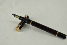 A Waterman Laureat converter fill fountain pen in red and black with two bands to barrel, one to cap