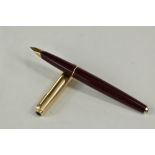 A Parker 65 aeromatic fountain pen in burgundy having rolled gold cap with Parker 14k nib. Approx