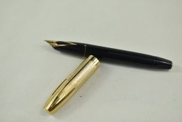 A Sheaffer Pen for Men snorkel fill fountain pen in black with gold cap having Sheaffer 14k nib.