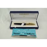 A boxed Waterman Converter Fill fountain pen in black with with rolled gold cap having 14ct nib.