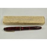 A boxed Conway Stewart 15 lever fill fountain pen in red black marble with single band to the cap