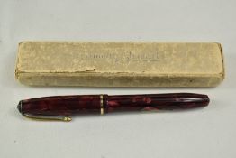 A boxed Conway Stewart 15 lever fill fountain pen in red black marble with single band to the cap