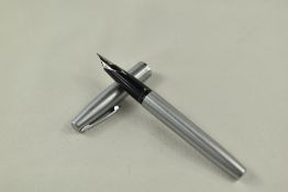 A Sheaffer 444 cartridge/ converter fountain pen in brushed steel with short clip and white spot