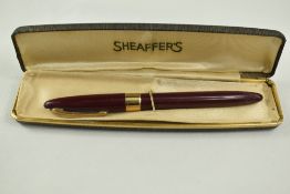 A Sheaffer Statesman Snorkel fountain pen in burgundy with broad band to the cap and white spot