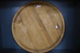 A large round wooden chopping board.