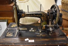 A Victorian Faudels London hand cranked sewing machine with fitted case