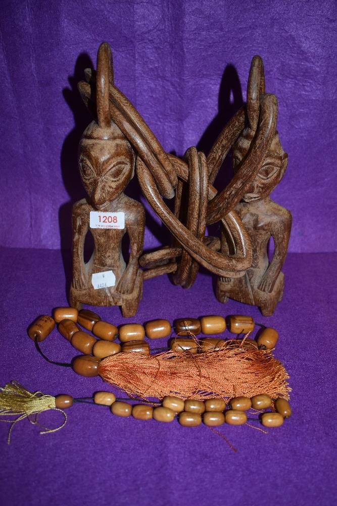 A tribal carved wooden one piece chain with two figures attached and an Olive wood necklace