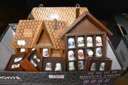 Twenty eight decorative thimbles in a variety of designs along with three small display stands