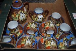 An Oriental Satsuma style tea set with eight cups.