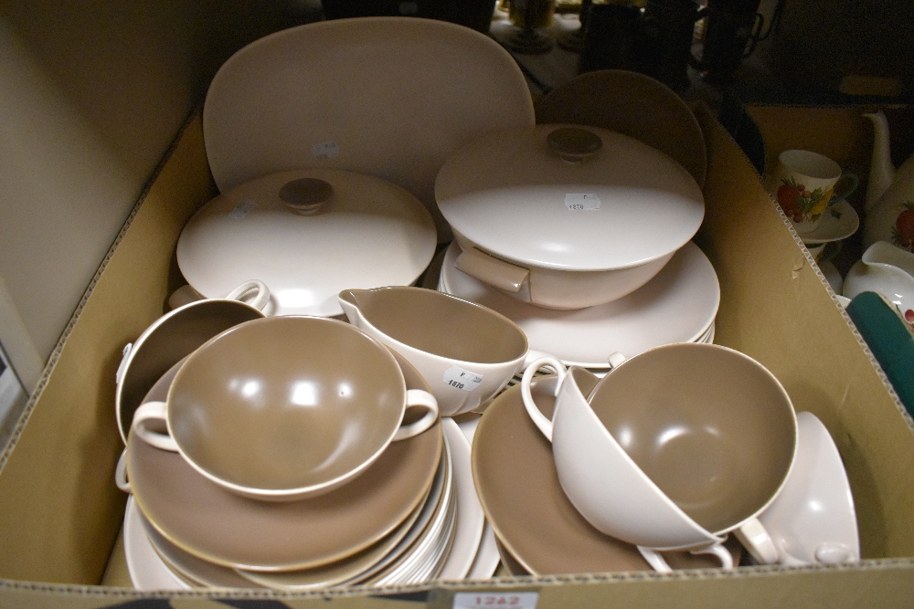 A mid century Poole pottery part dinner service in a cream and brown glaze.