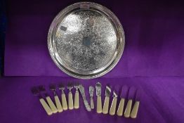 A circular silver-plated tray sold together with silver plated fish cutlery (uncased)