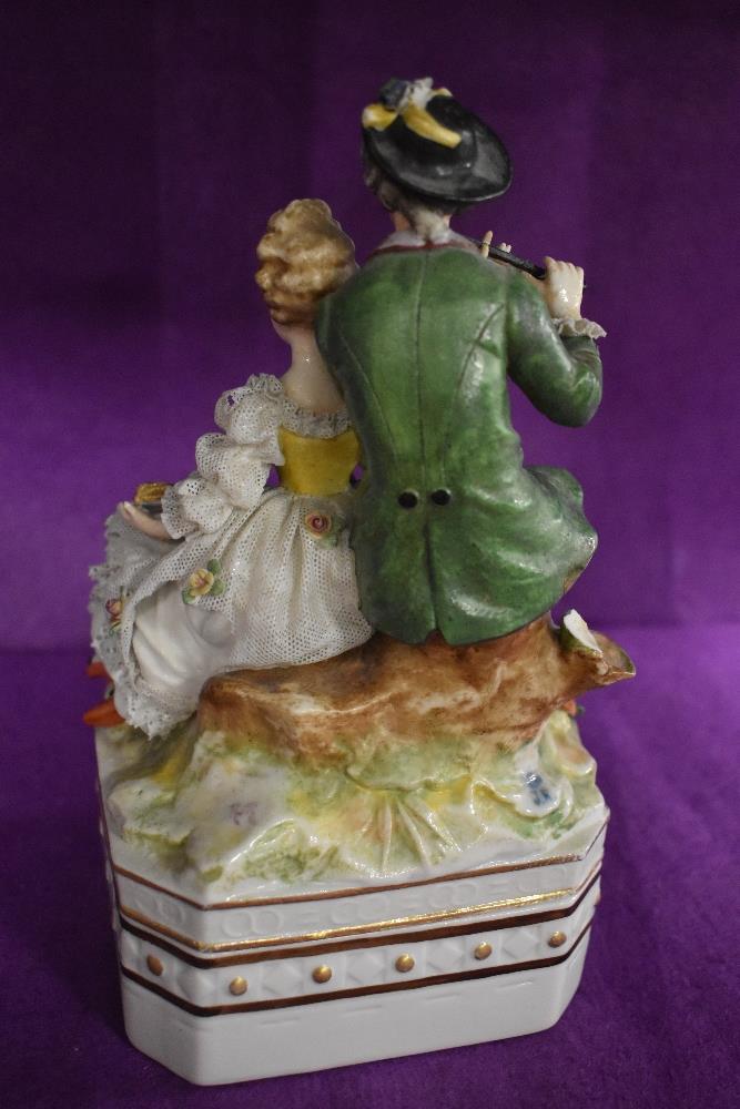 A German made porcelain lidded container with 18th century couple playing music in a Dresden style. - Image 2 of 2