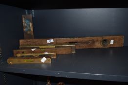 A selection of early 20th century spirit levels having wooden bodies with brass mounts including